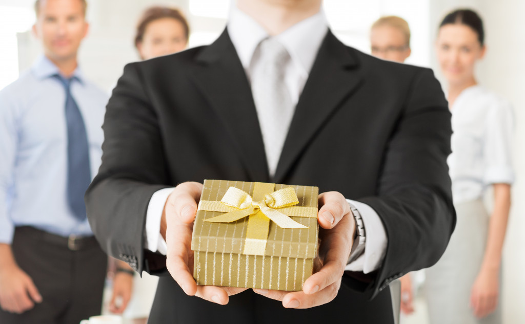 business man giving a box of gift